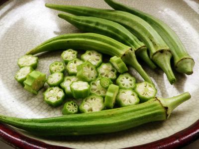 Packet of Seeds 'n Such Cow Horn Okra Seeds, showing a close-up of the seed packet with 50 seeds for planting.