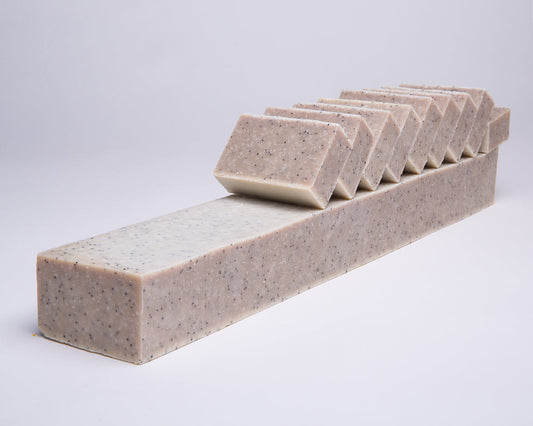 Bar of Soap for Sinners with salt, seaweed, and eucalyptus, showcasing a natural, textured appearance with a white and green color scheme.