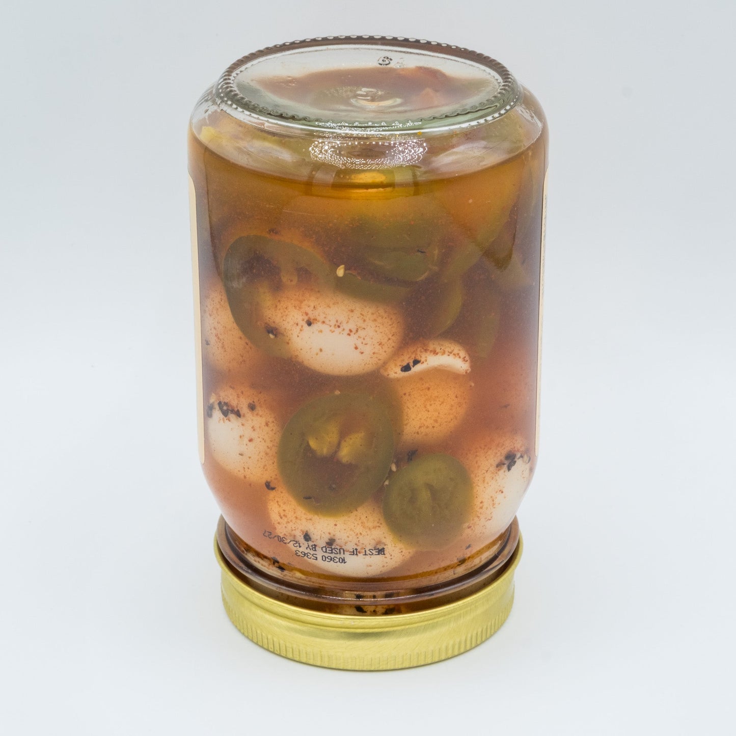Canned pickled spicy quail eggs from Amish Country Store, showing a jar filled with spicy marinated quail eggs.
