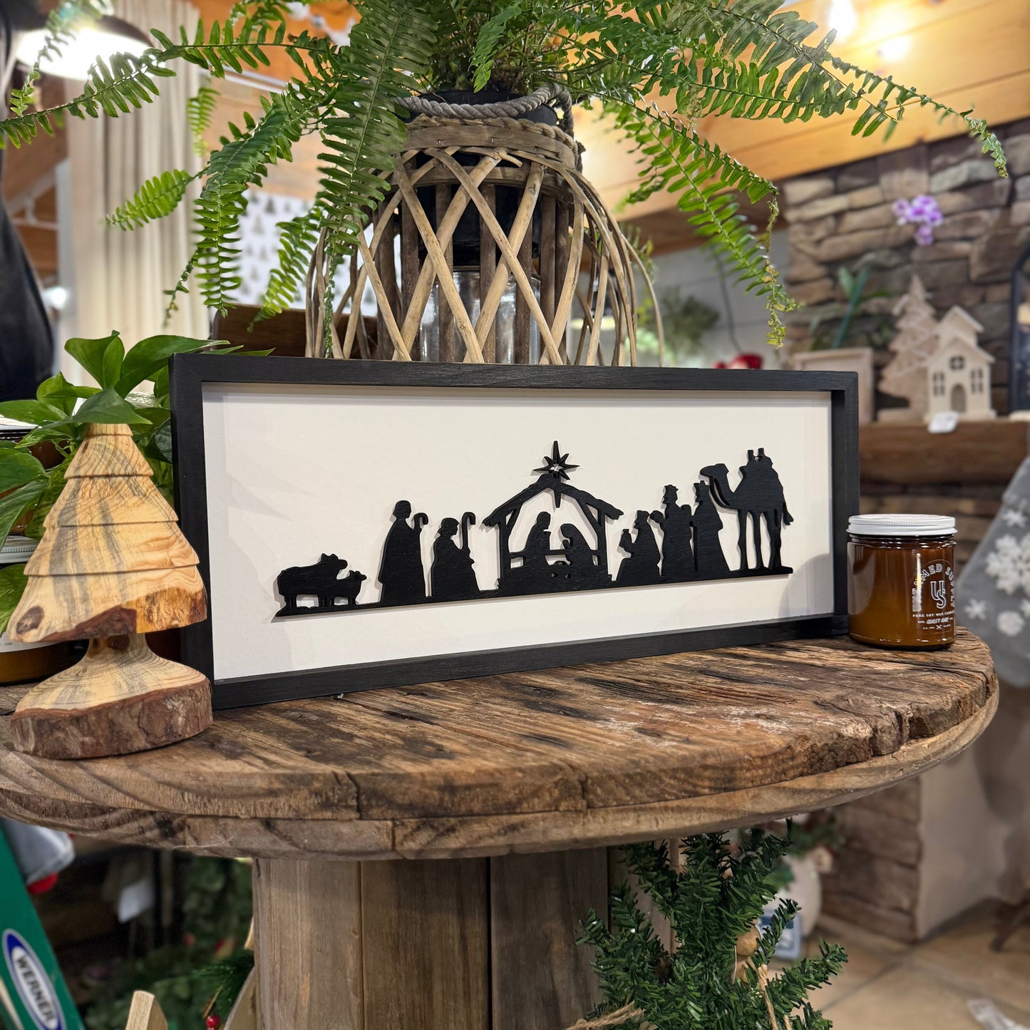 Still Magnolia Nativity sign with festive holiday design, featuring a detailed depiction of the nativity scene on a rustic wooden background.