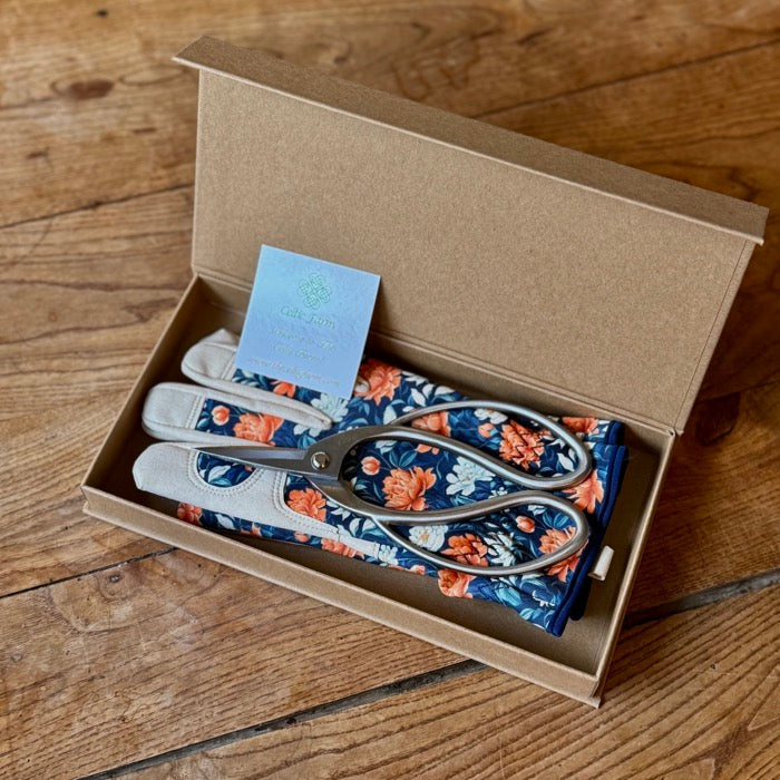 Garden Gift Box from The Celtic Farm featuring green and yellow gloves and garden snips for gardening tasks.