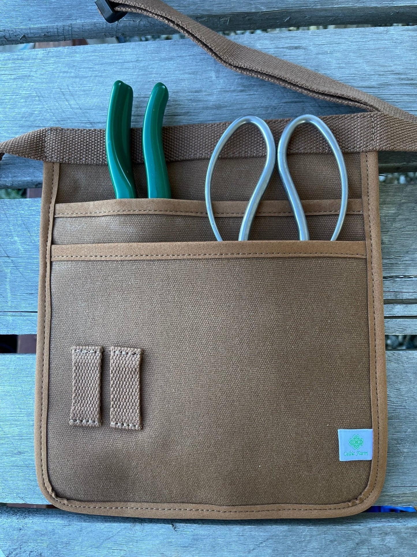 Waxed canvas garden tool belt by The Celtic Farm, hunter green, with multiple pockets for gardening tools.