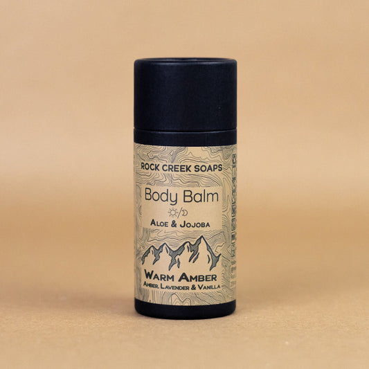 Solid lotion bar in warm amber and vanilla scent with French lavender, designed for nourishing skin, by Rock Creek Soaps.
