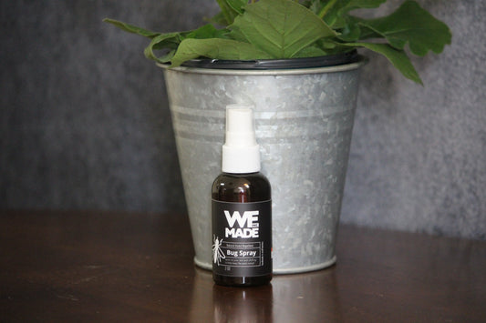 WE Made bug spray in a 2 oz. bottle, featuring a spray nozzle for easy application and protection against insects.