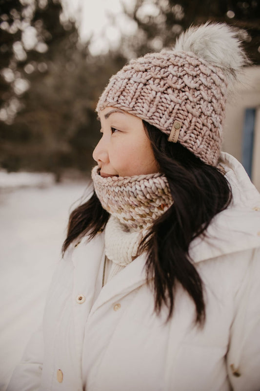 Pearl gray Woolly Bear Knits merino wool knit hat with a fluffy faux fur pom pom on top.