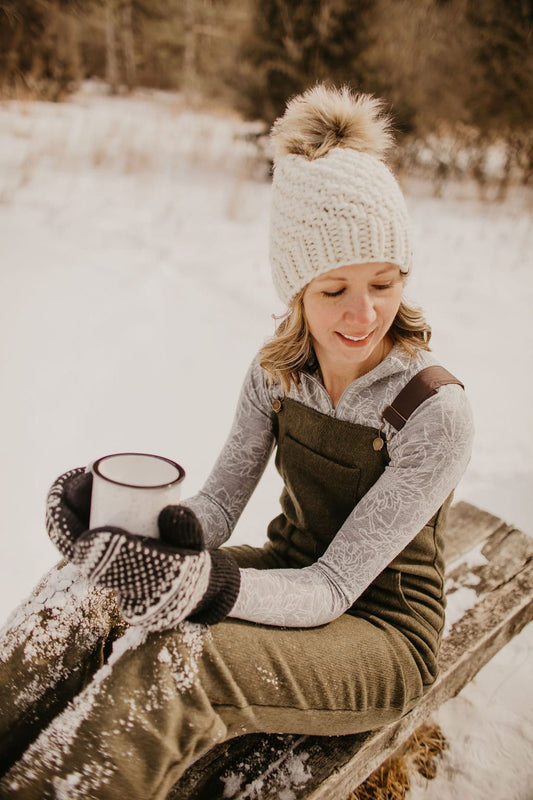 Ivory Peruvian wool knit hat with faux fur pom pom by Woolly Bear Knits, featuring cozy textured wool and fluffy pom adornment.