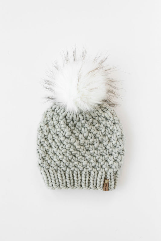 Light gray Peruvian wool knit hat with faux fur pom-pom from Woolly Bear Knits, perfect for warm winter style.