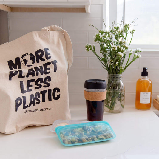 Organic tote bag by ZeroWasteStore.com with "More Planet Less Plastic" printed, made for eco-friendly shopping and sustainability.