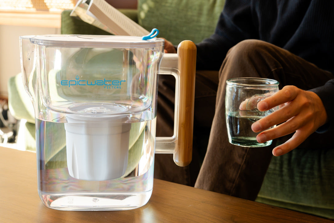 Epic Water Filters Pure XP pitcher in red for reducing fluoride, PFAS, and parasites; clear pitcher with filter inside.
