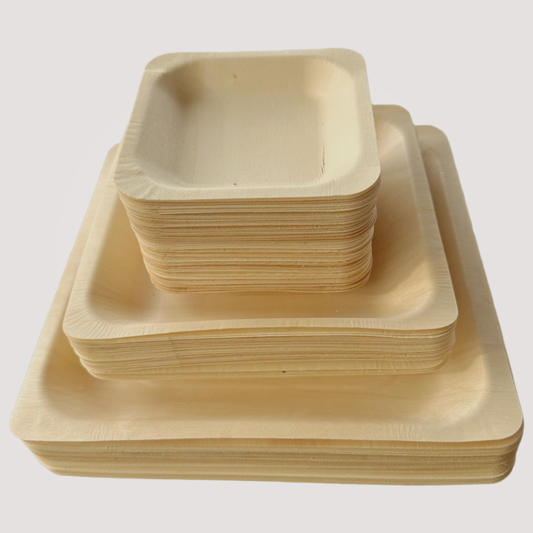 Set of four 4.5-inch eco-friendly square wooden plates by MicRic, made from bamboo and palm leaf, arranged on a table.