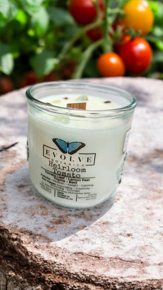 Evolve Botanica Rocks Candle Heirloom Tomato soy candle with wood wick, prehnite, and red jasper stones, in a decorative jar.