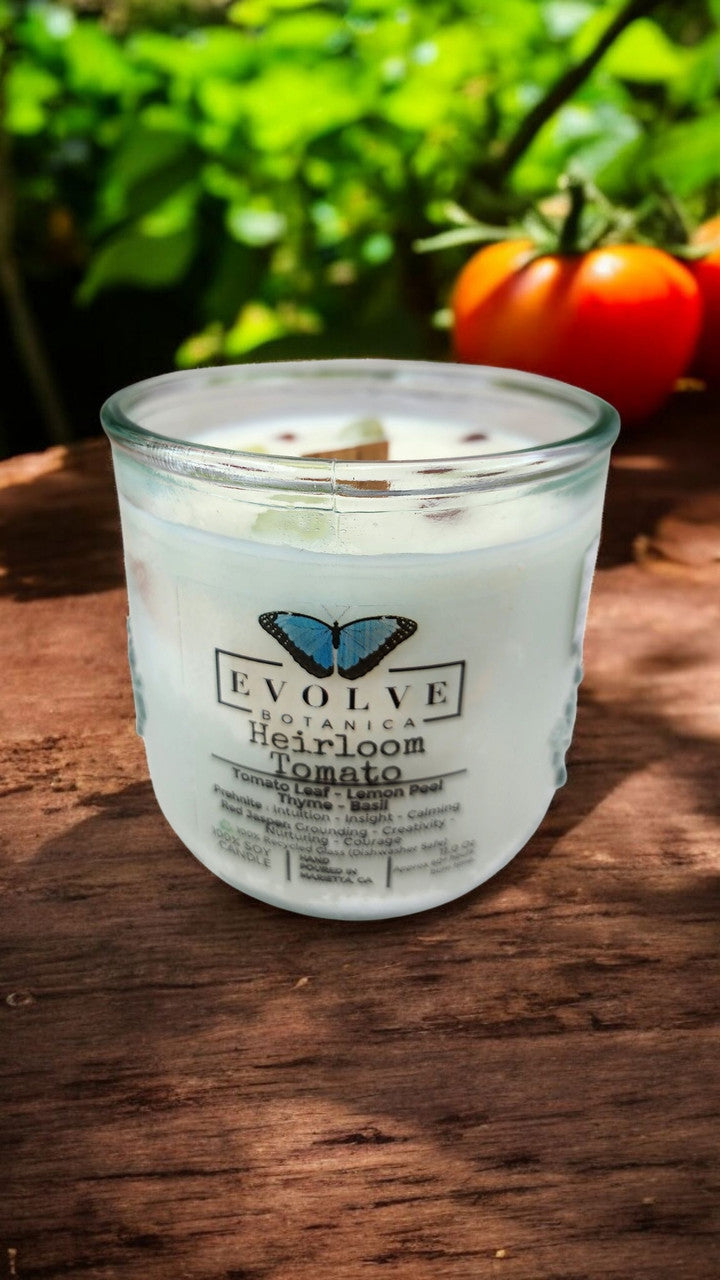 Evolve Botanica Rocks Candle Heirloom Tomato soy candle with wood wick, Prehnite and Red Jasper gemstones, burning softly.