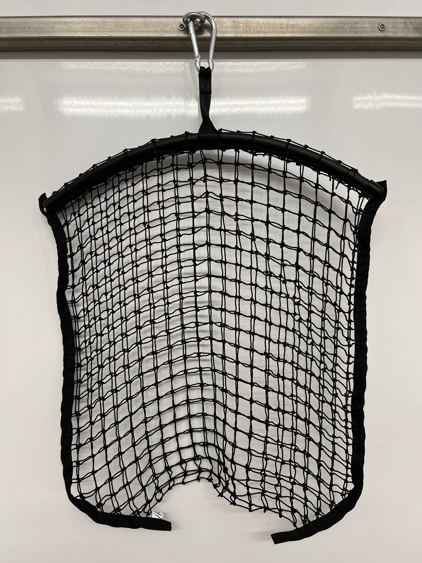 Black regular haynet from Haylo Haynets, LLC, showing a sturdy net for storing or feeding hay in a farm or stable setting.