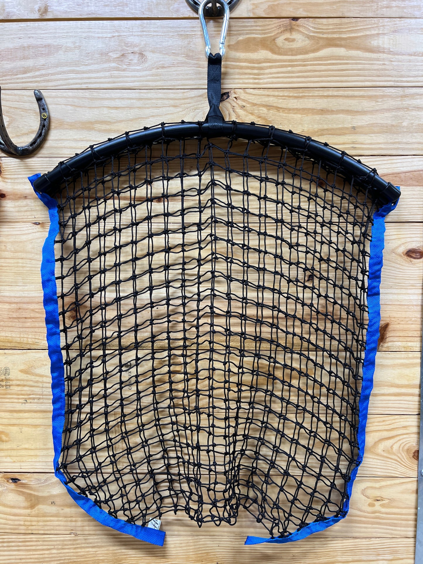 Blue regular haynet by Haylo Haynets, LLC, showing sturdy mesh design for hay storage and feeding.