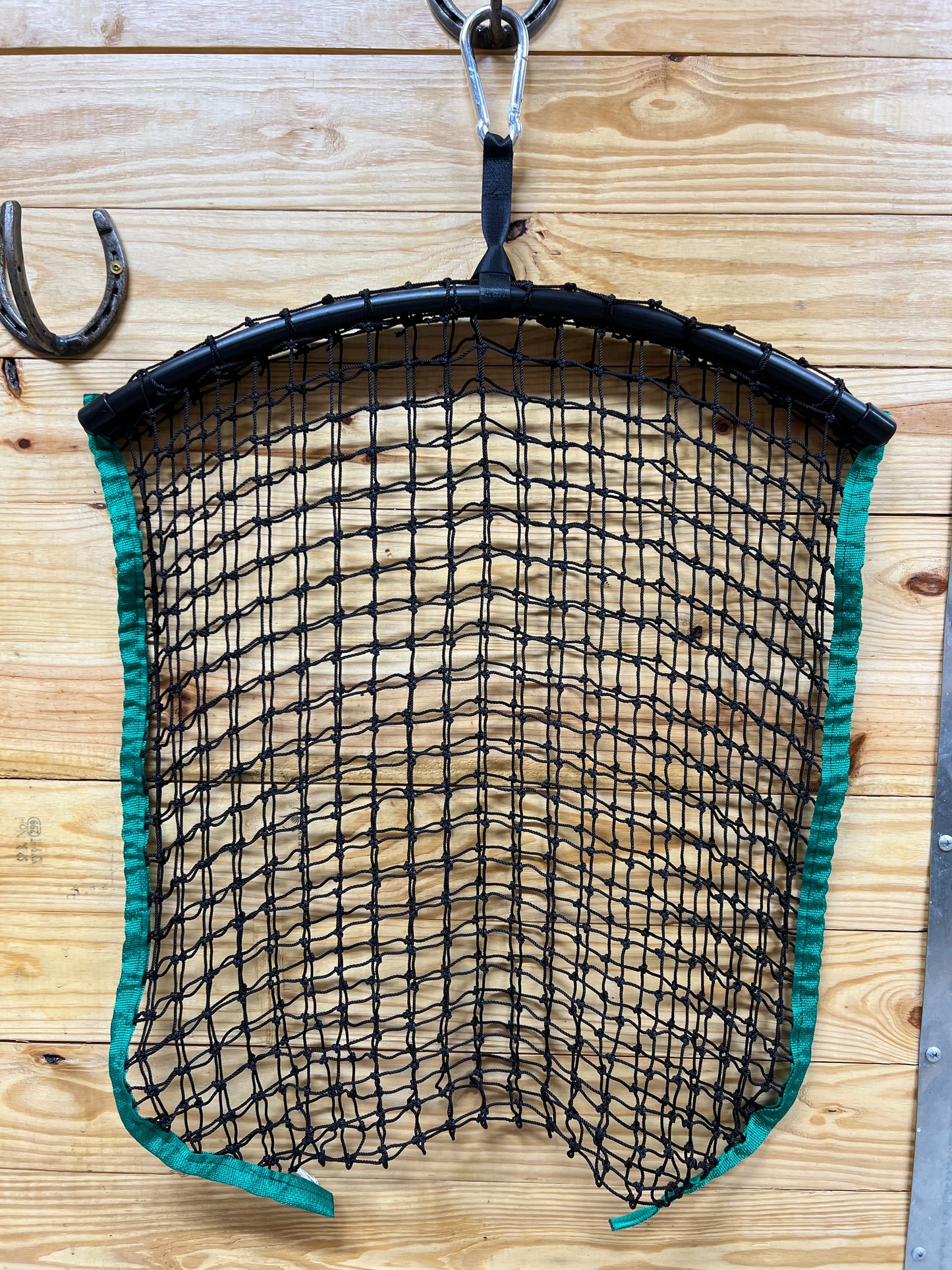 Green regular haynet from Haylo Haynets, LLC, showing a sturdy, mesh haynet with a secure top opening for feeding hay to horses.