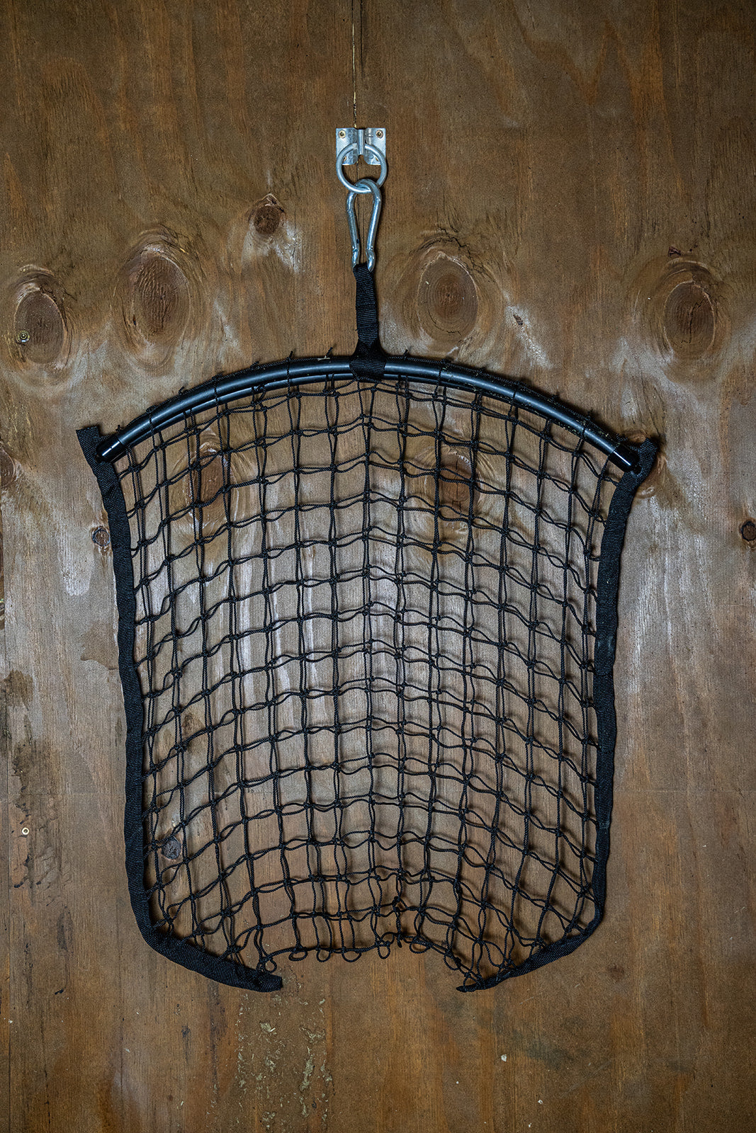 Black regular haynet from Haylo Haynets, LLC with tightly woven mesh for safe hay storage and feeding.