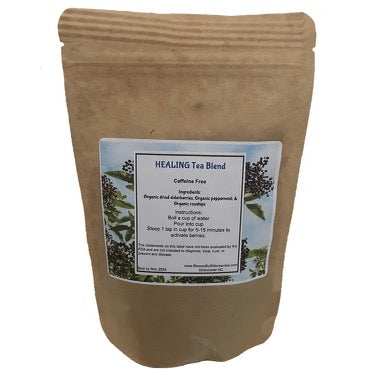 Blessed by Elderberries healing blend elderberry tea in a mug with tea leaves and elderberries, showcasing a soothing herbal beverage.