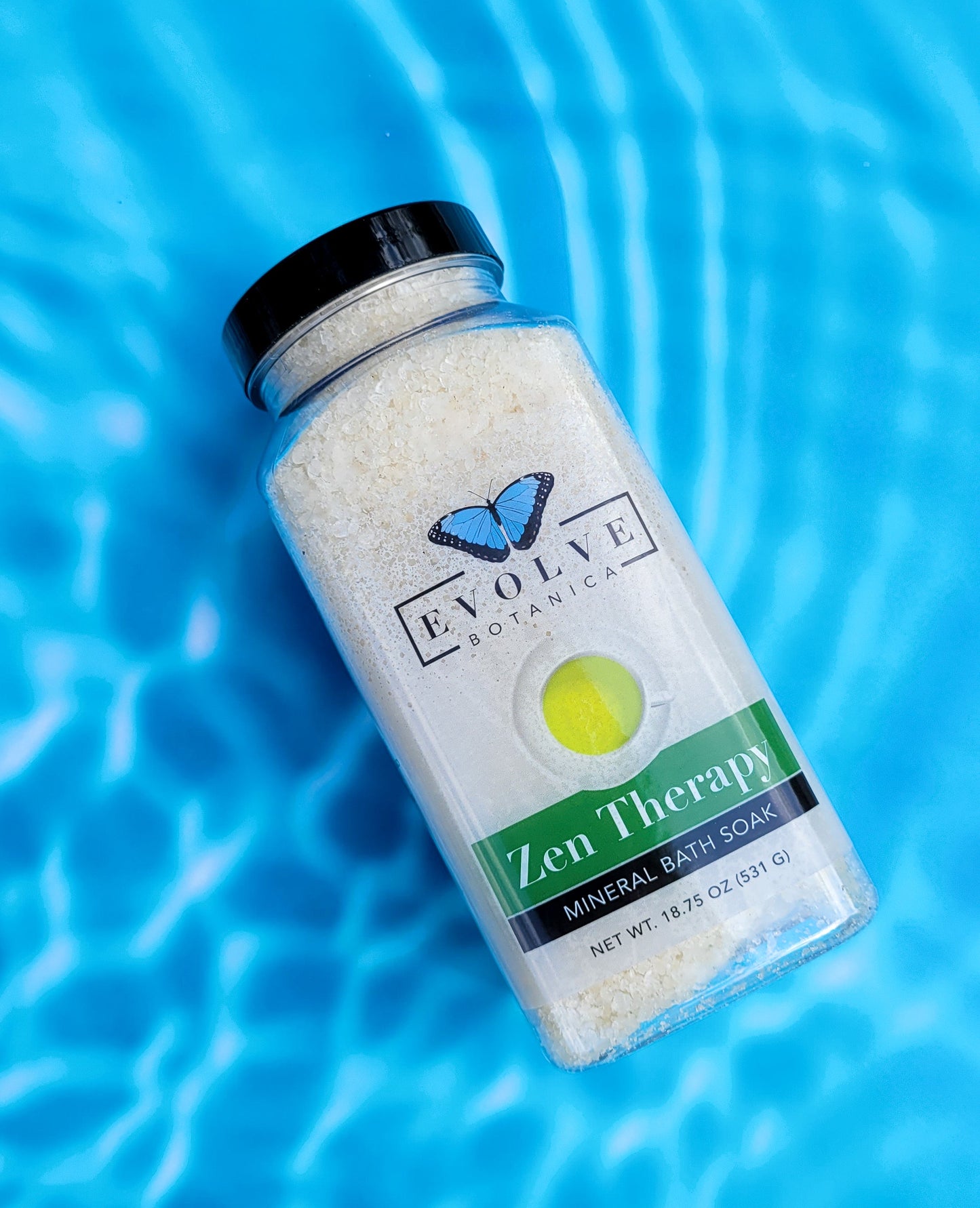 Evolve Botanica Mineral Soak Zen bath salt in a clear jar with label, showing pink and white bath salts ready for relaxing bath.