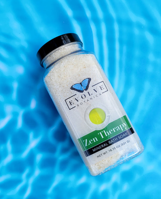 Evolve Botanica Mineral Soak Zen bath salt in a clear jar with label, showing pink and white bath salts ready for relaxing bath.
