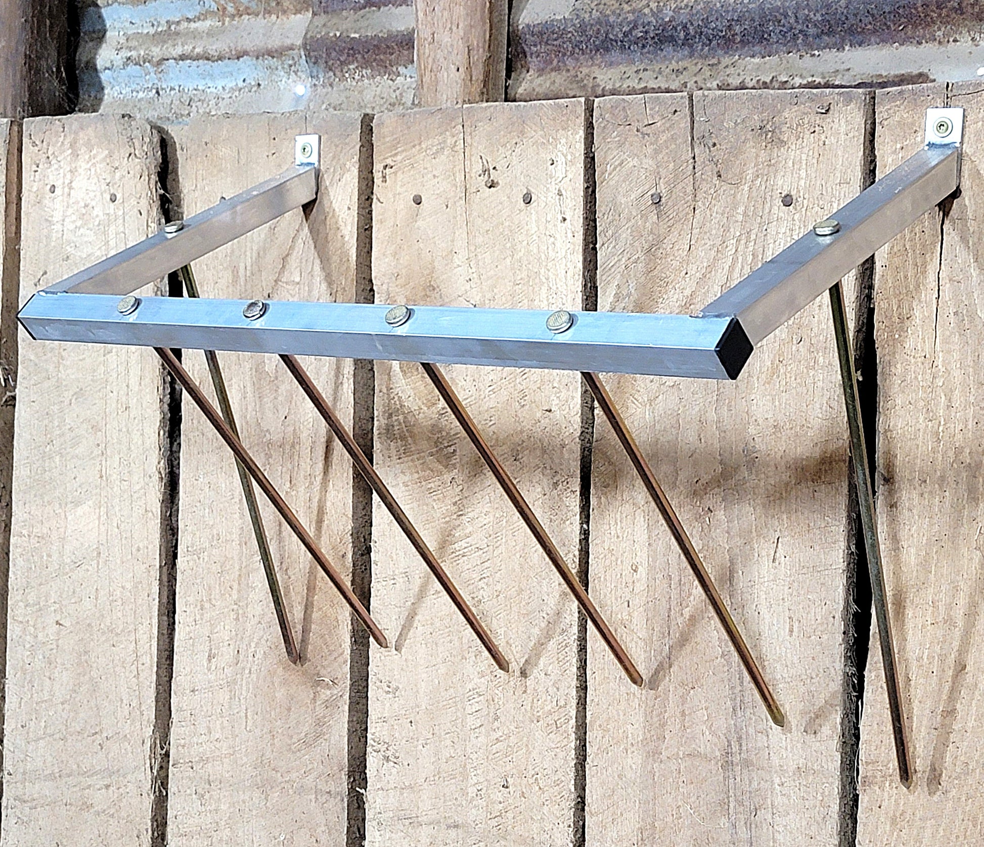 24-inch wall-mounted sheep and goat hay feeder made of USA-made aluminum, suitable for fences, stalls, and pens.