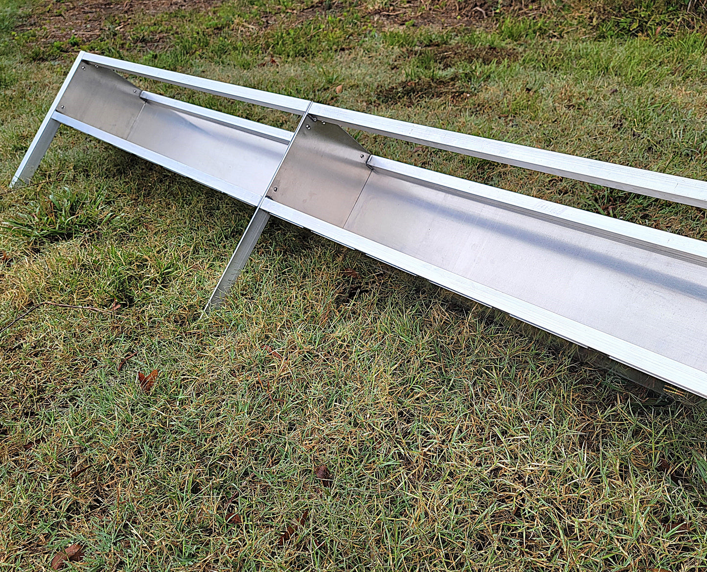96-inch welded aluminum sheep and goat V trough feeder with anchors, ideal for livestock feeding, made in the USA.