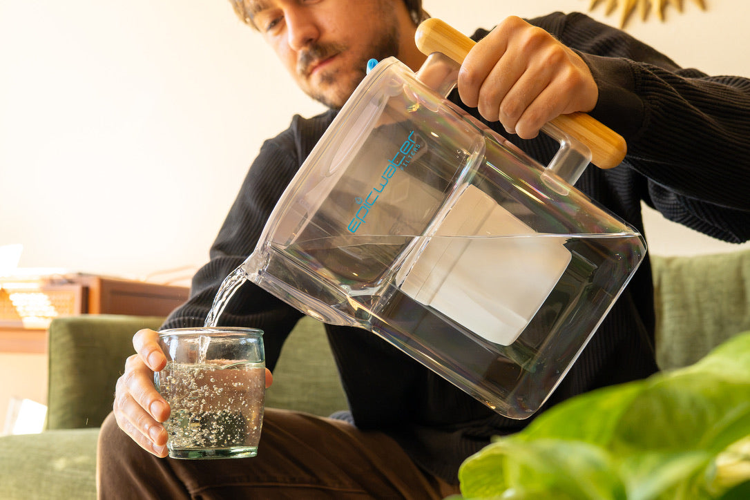 Epic Water Filters Pure XP pitcher with red handle and transparent body, designed to reduce fluoride, PFAS, and parasites from water.