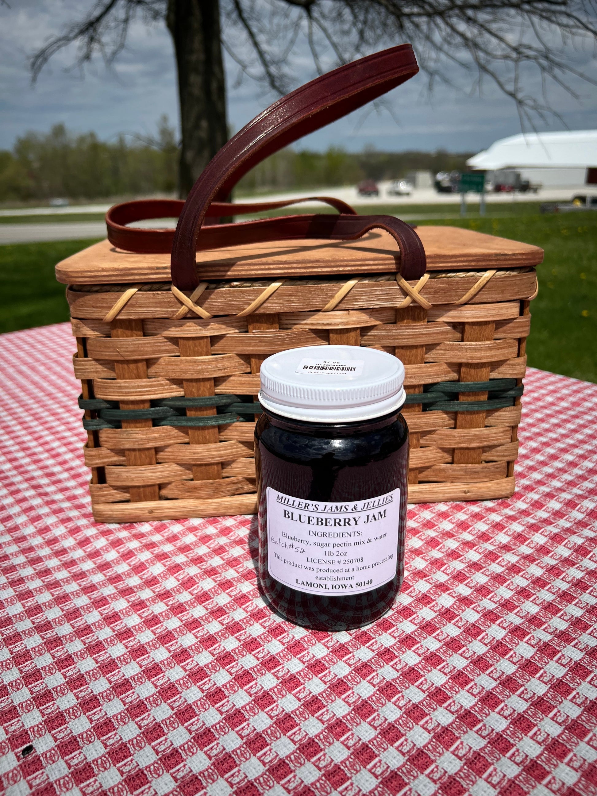 Amish Country Store Miller's Blueberry Jam jar with a label, showcasing fresh blueberries and Amish-made Amish jam product.