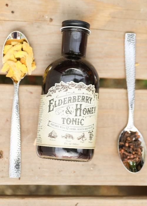 Elderberry and honey tonic in a glass bottle with a dropper, showcasing the herbal supplement from Roots and Leaves LLC.