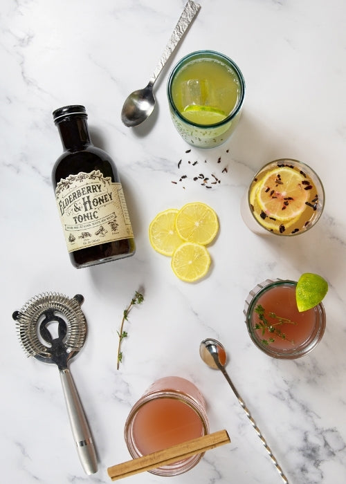 Elderberry and honey tonic bottle from Roots and Leaves LLC, with a dark glass bottle and natural label design.