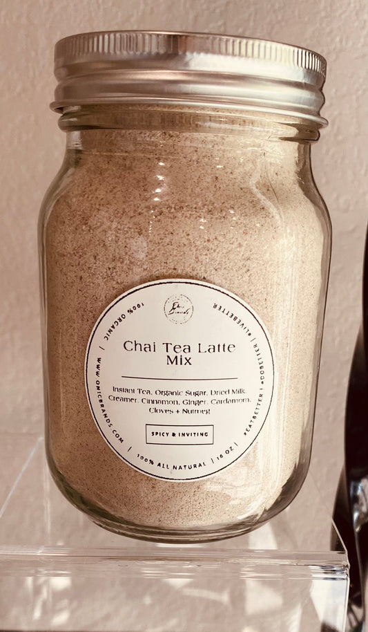 Creamy chai tea latte in a cup with cinnamon and tea leaves from Onic Brands LLC, served hot with a frothy top.