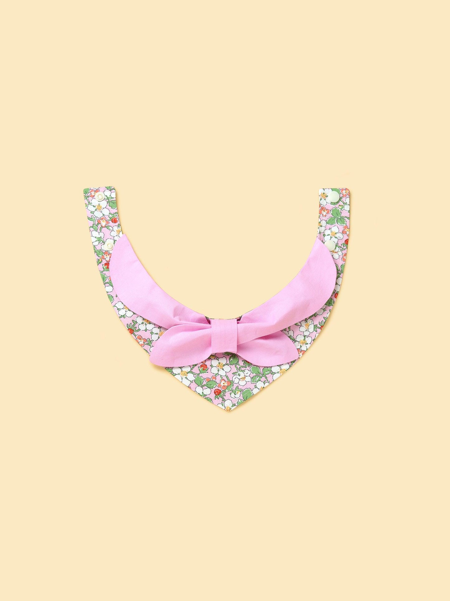 Pink floral bandana for babies with bowtiful garden pattern by BarkBarkBaby, featuring pink and green floral design.
