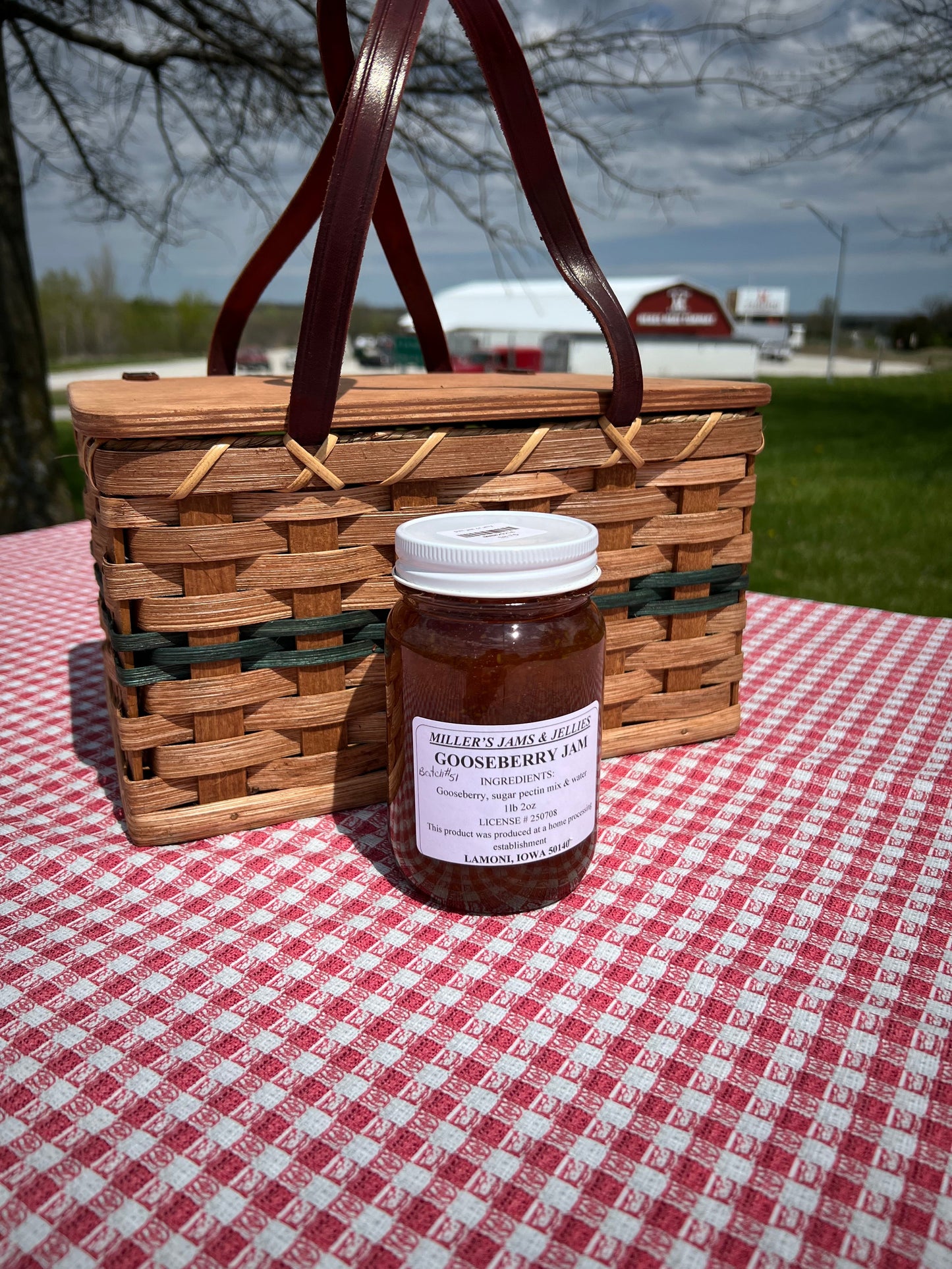 Amish Country Store Miller’s Gooseberry Jam jar with label showing fresh gooseberries and jam texture, on a rustic wooden surface.