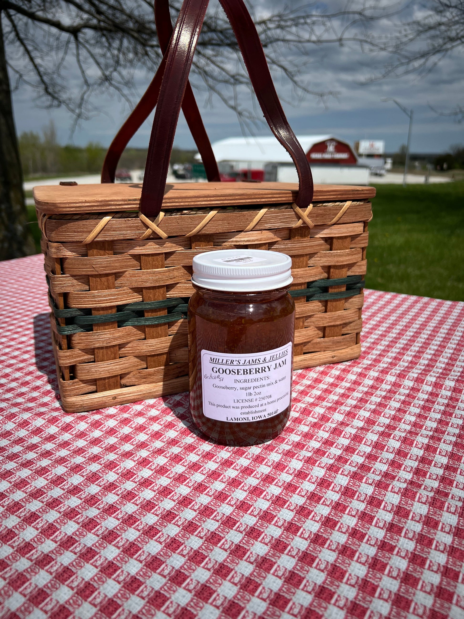 Amish Country Store Miller’s Gooseberry Jam jar with label showing fresh gooseberries and jam texture, on a rustic wooden surface.