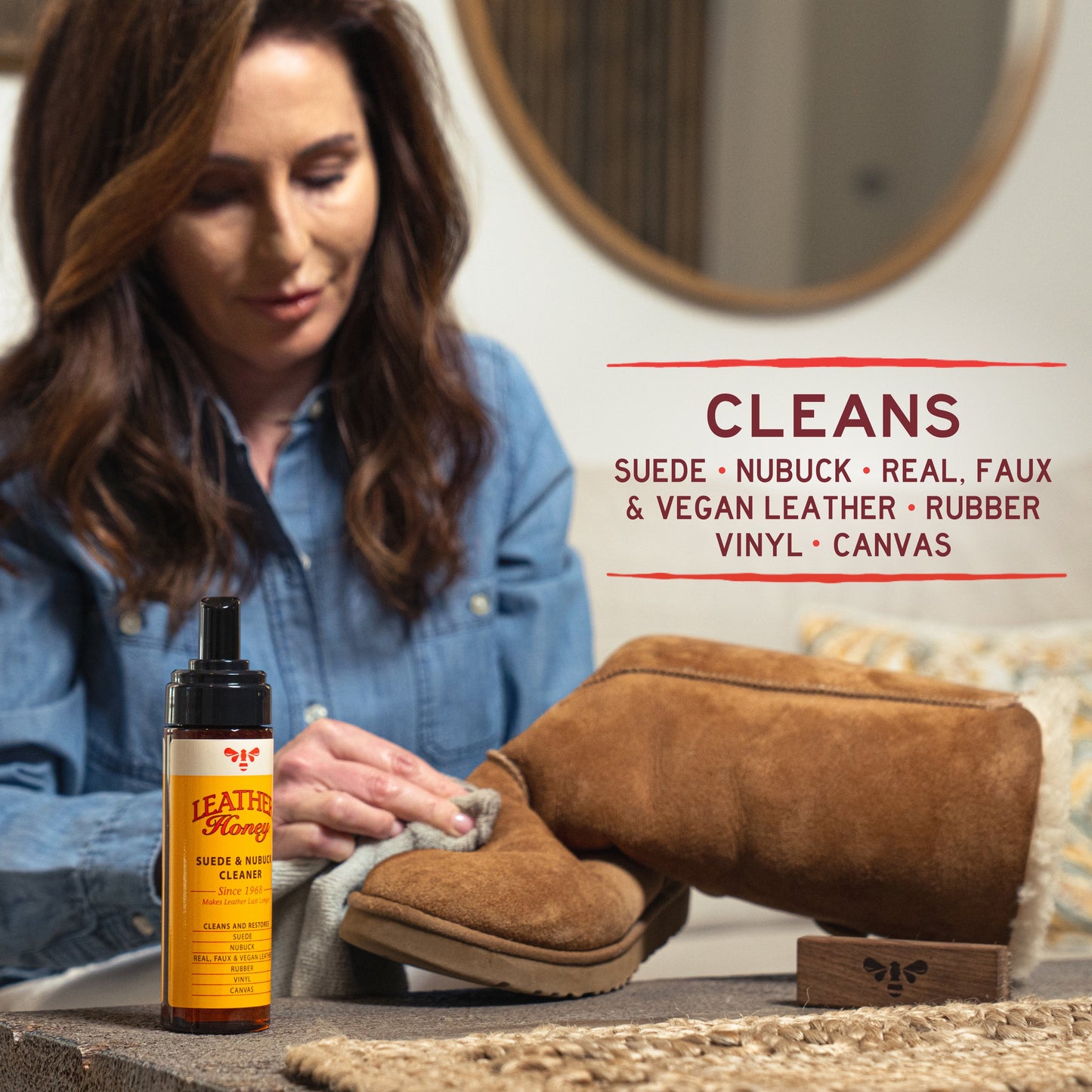Leather Honey Suede and Nubuck Cleaner for leather care, showing a spray bottle and cleaning cloth on a leather surface.