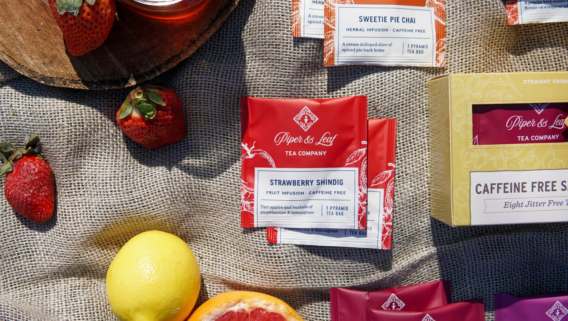 Assorted caffeine-free tea bags in a tasting flight box by Piper and Leaf Tea Co. with 12 tea bags displayed.