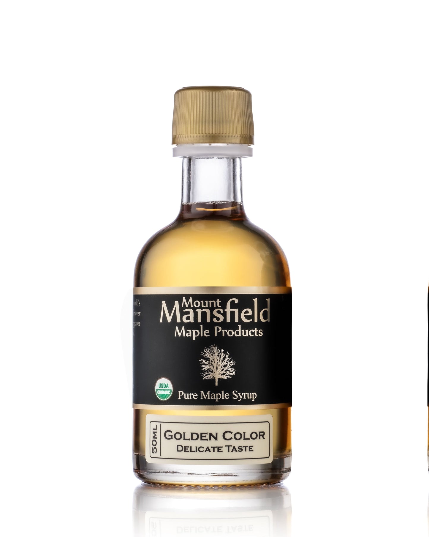 50ml bottle of Mount Mansfield Organic Pure Vermont Maple Syrup Grade Sampler with golden, delicate syrup in a clear glass bottle.