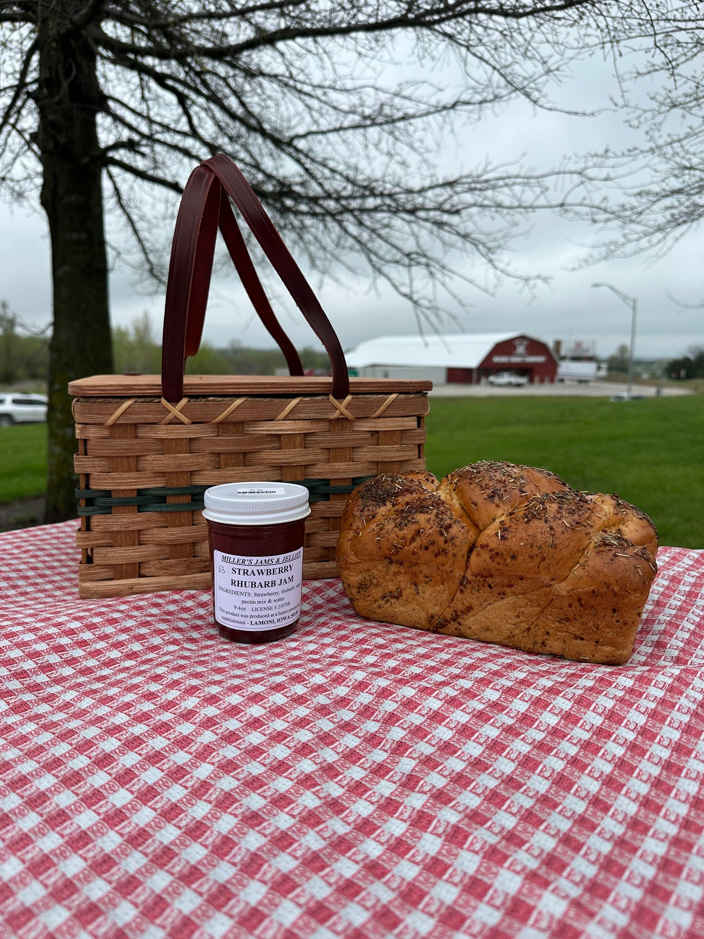 Amish Country Store Miller's strawberry rhubarb jam jar with a label, showcasing fresh strawberries and rhubarb pieces inside.