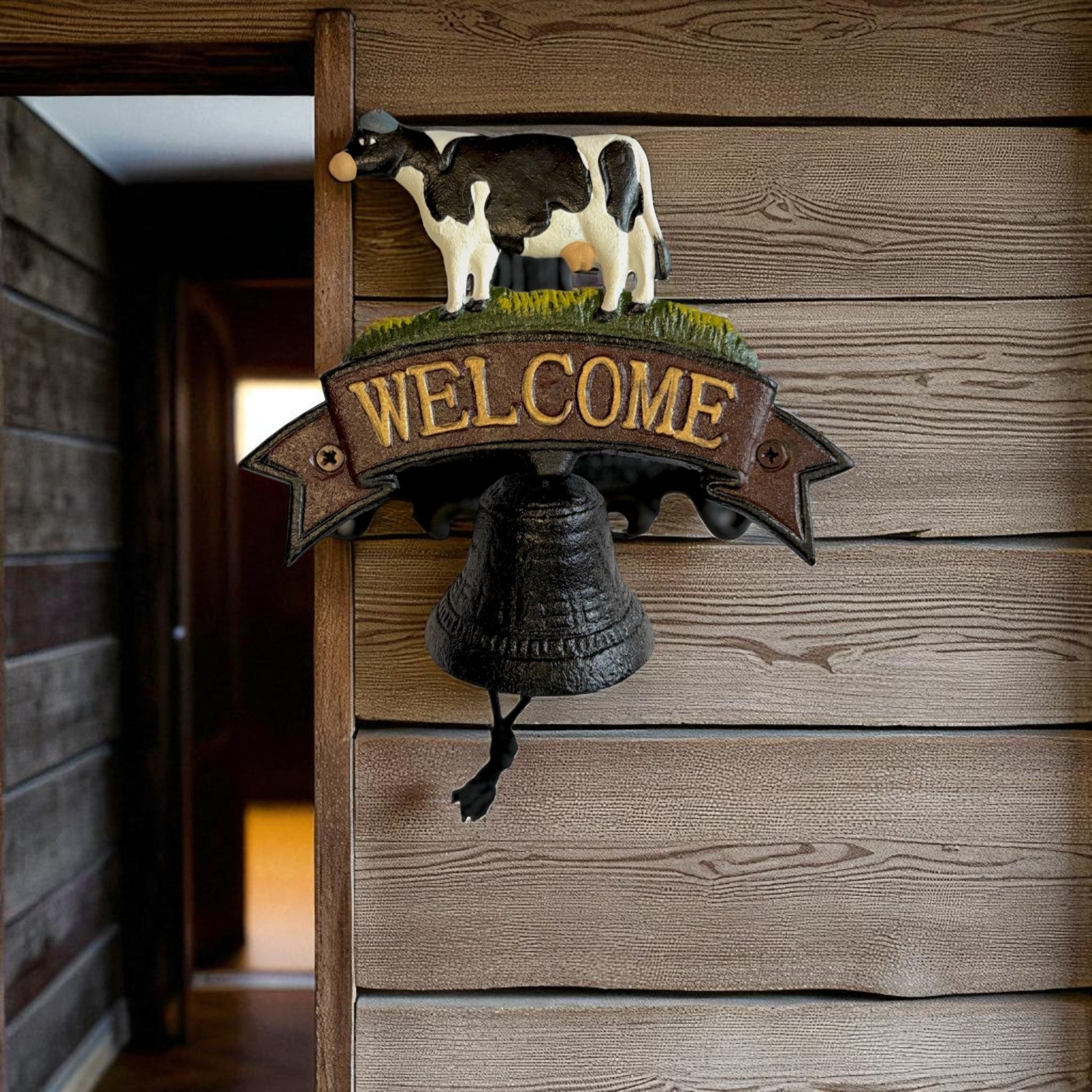 Rustic cast iron cow welcome bell sign with farmhouse style decor, featuring Iron & Blossom branding and vintage farm charm.