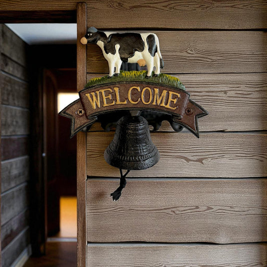Rustic cast iron cow welcome bell sign with farmhouse style decor, featuring Iron & Blossom branding and vintage farm charm.