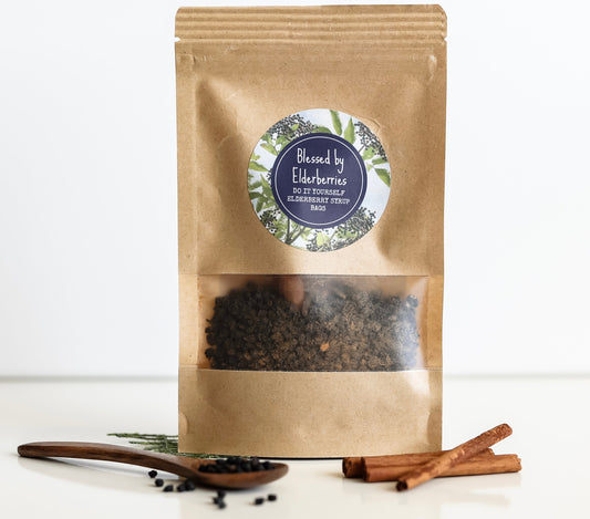 DIY pint-size elderberry syrup kit by Blessed by Elderberries, including bottles, ingredients, and brewing supplies for homemade syrup.