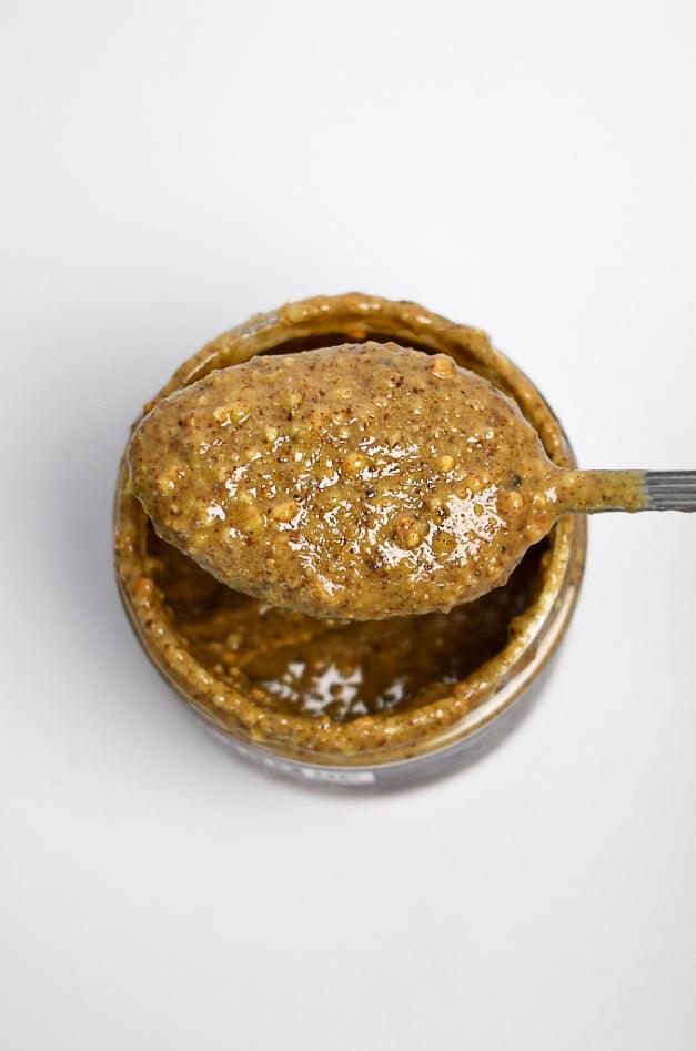 Creamy Maple Bliss nut butter from Mixed Up Foods with maple, walnut, and pecan nuts in an 8 oz jar.