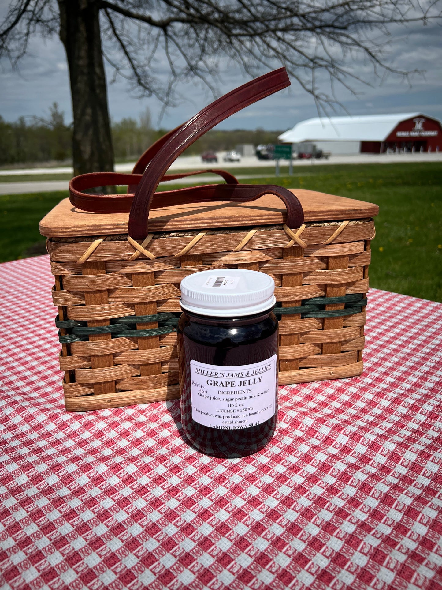 Jar of Amish Miller’s Grape Jelly from Amish Country Store, smooth purple jam with a label and lid, on a wooden surface.