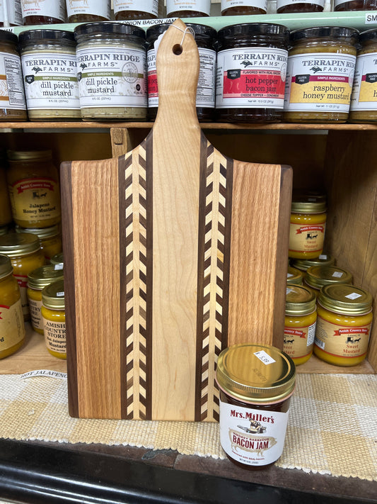 Handmade Amish wheat inlay cutting board made from mixed hardwoods, featuring a paddle shape perfect for kitchen use.