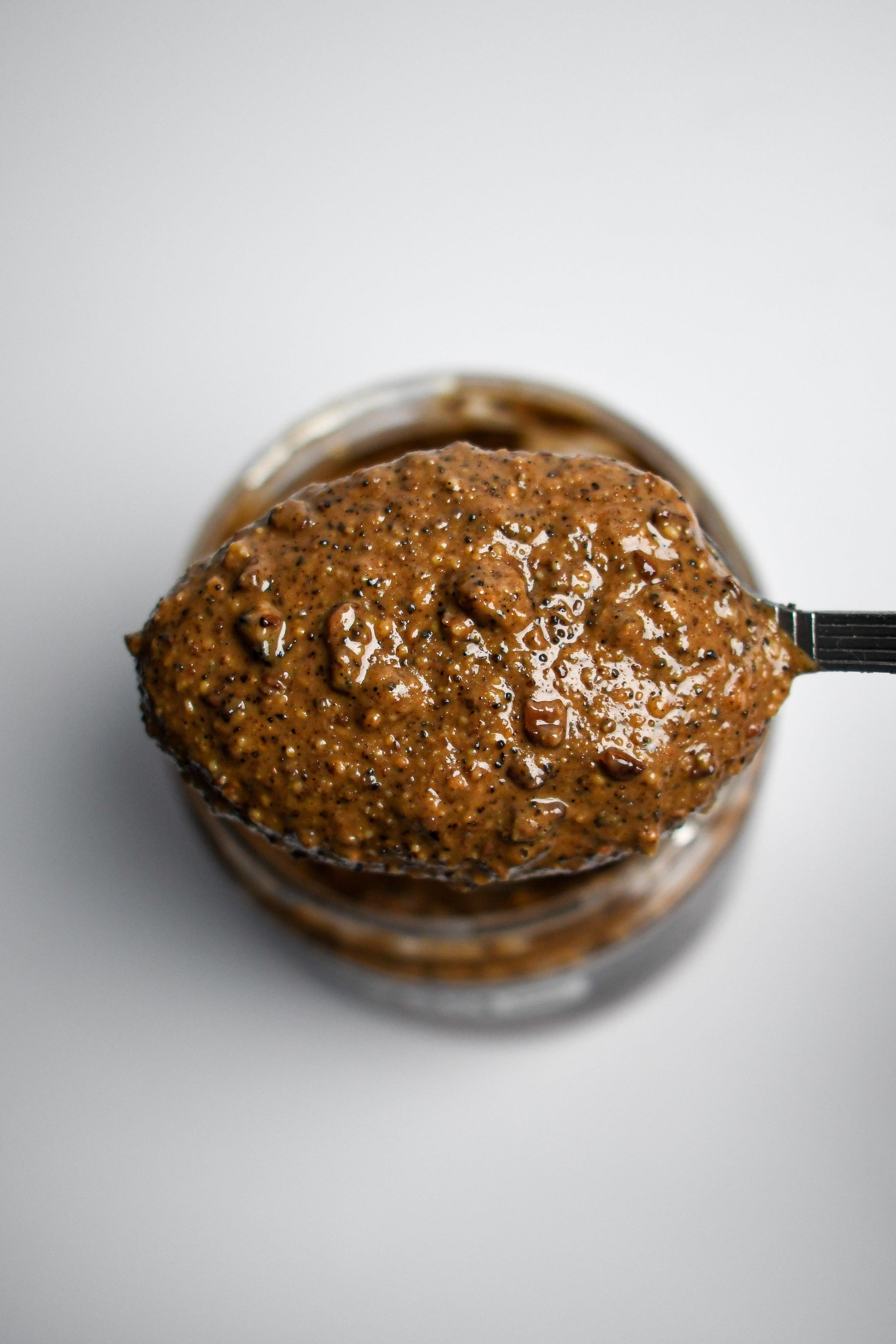 Crunchy "Mud Season" nut butter by Mixed Up Foods with cacao nibs and coffee nuts in 7.5 oz jar, showing the textured spread.