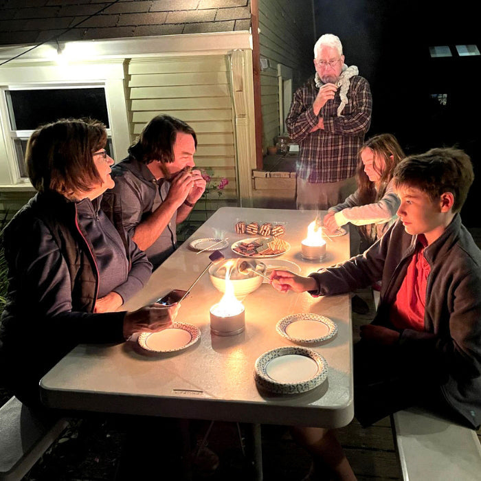 City Bonfires S'mores Family Pack outdoors set with graham crackers, marshmallows, and chocolate on a picnic table.