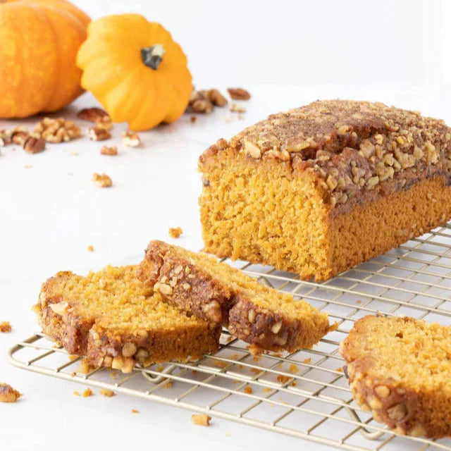Slice of pumpkin streusel coffee cake from Beatrice Bakery, showing a golden-brown topping and moist pumpkin-flavored cake