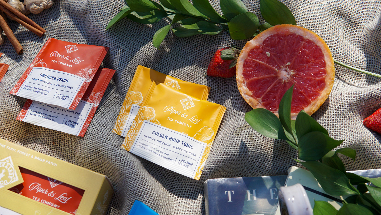 Assorted caffeine-free tea bags from Piper and Leaf Tea Co. in a tasting flight box, displayed with individual tea bag packaging.