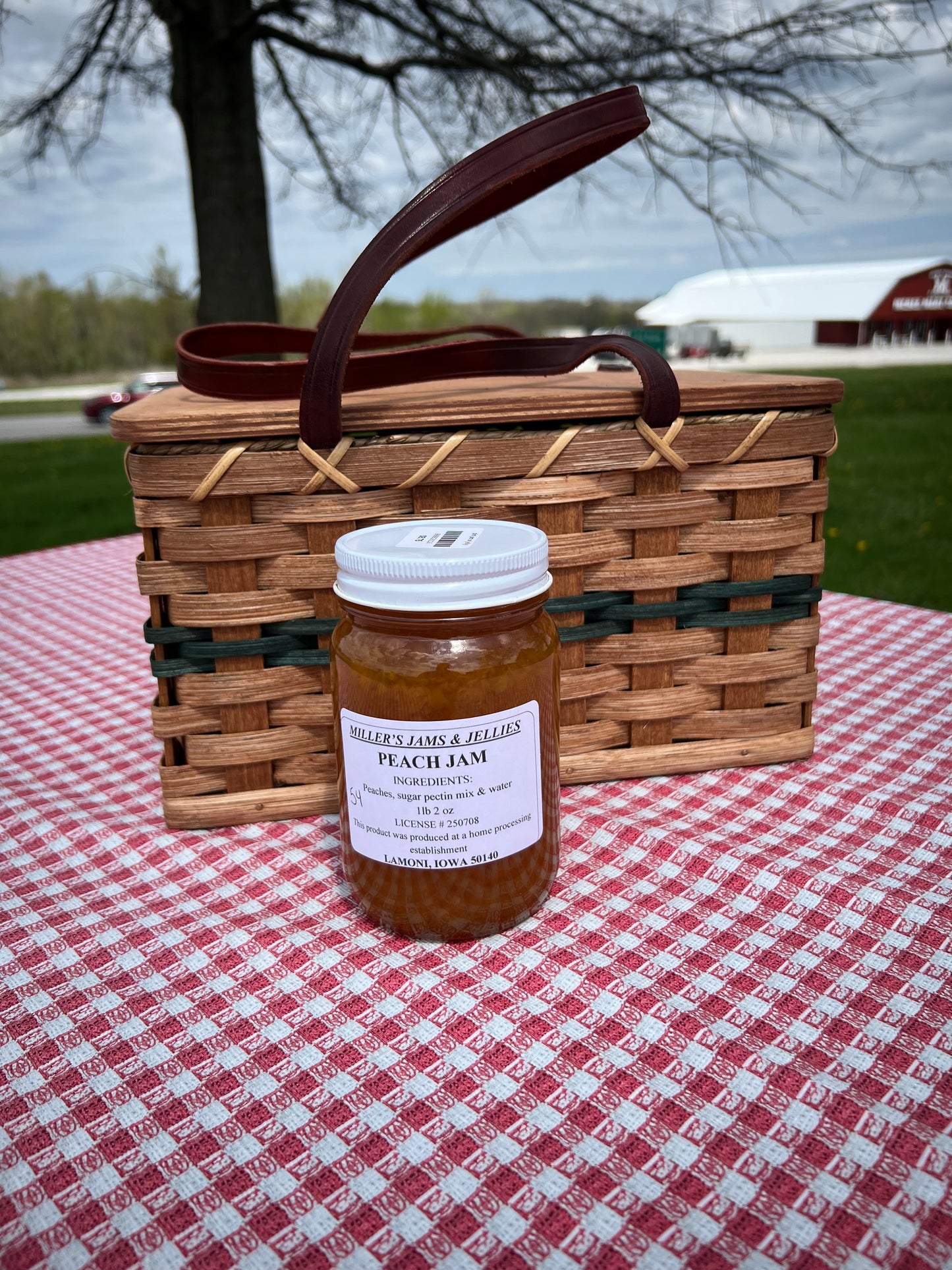 Amish Country Store Miller's Peach Jam jar with a label, showcasing rich, golden peach jam inside a clear glass jar.