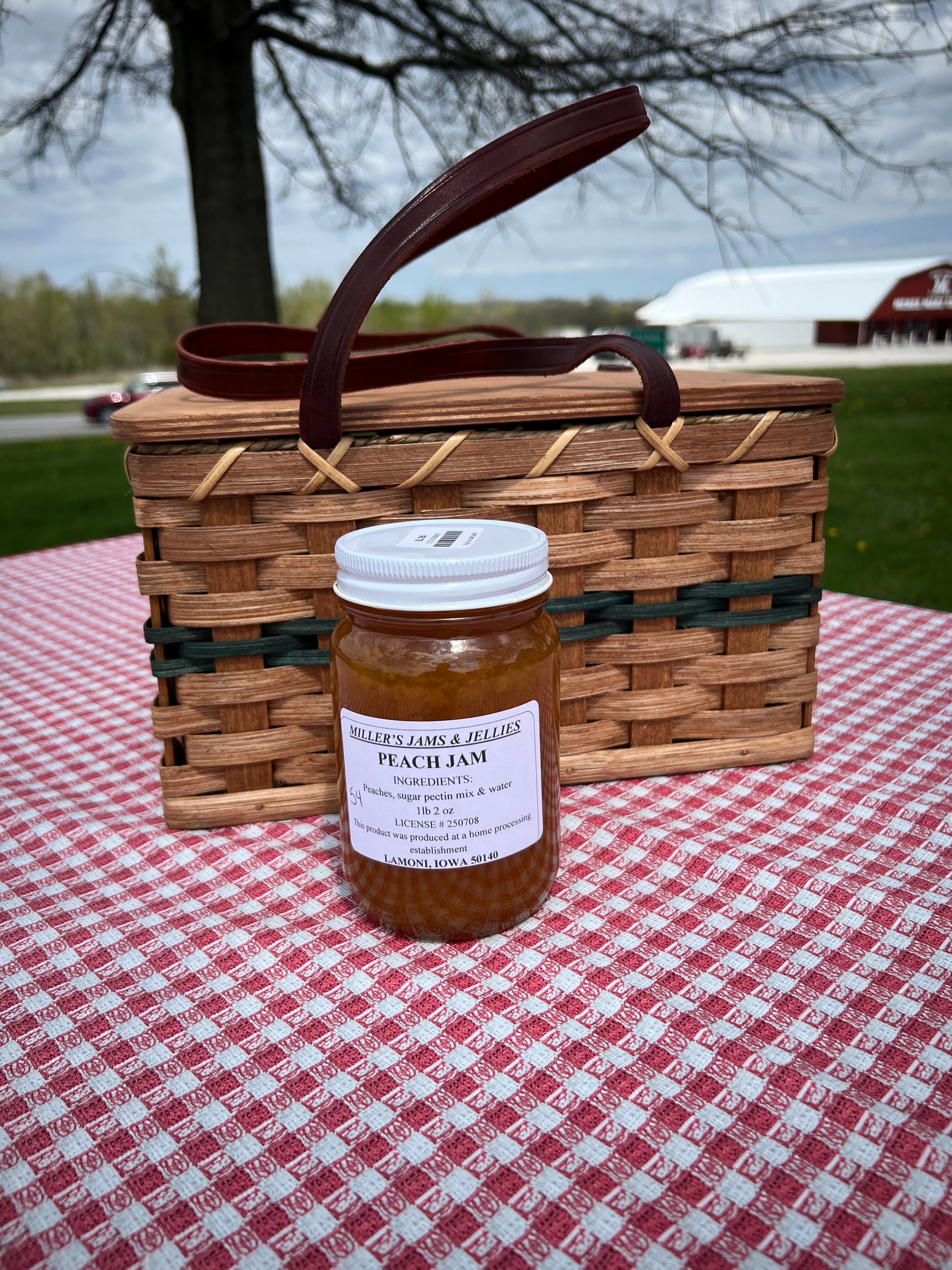 Amish Country Store Miller's Peach Jam jar with a label, showcasing rich, golden peach jam inside a clear glass jar.