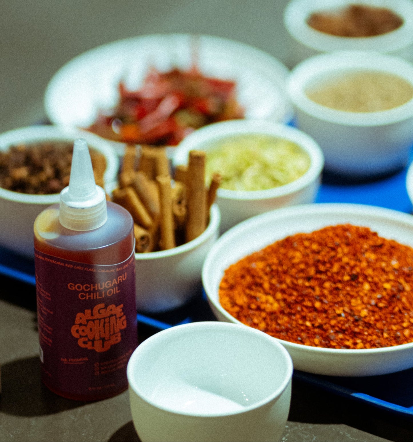Algae Cooking Club infused oil duo bottles, featuring vibrant labels and clear glass containers with golden-colored oils.